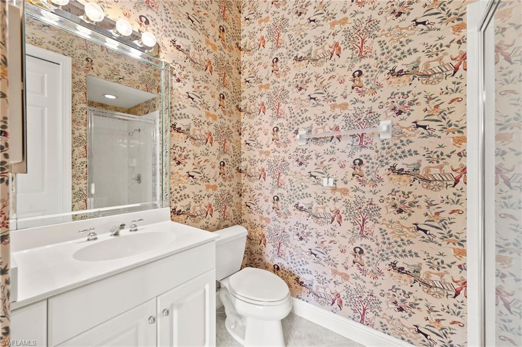 527 Terracina Way Naples, FL 34119 - Photo 36 of 48 a bathroom with a sink toilet and a mirror