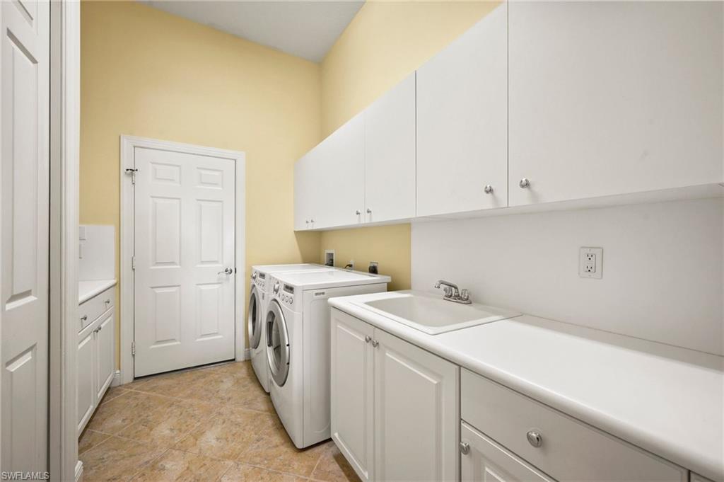 527 Terracina Way Naples, FL 34119 - Photo 38 of 48 a utility room with dryer and washer