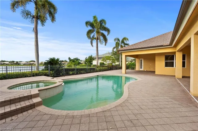 a swimming pool with outdoor seating and yard
