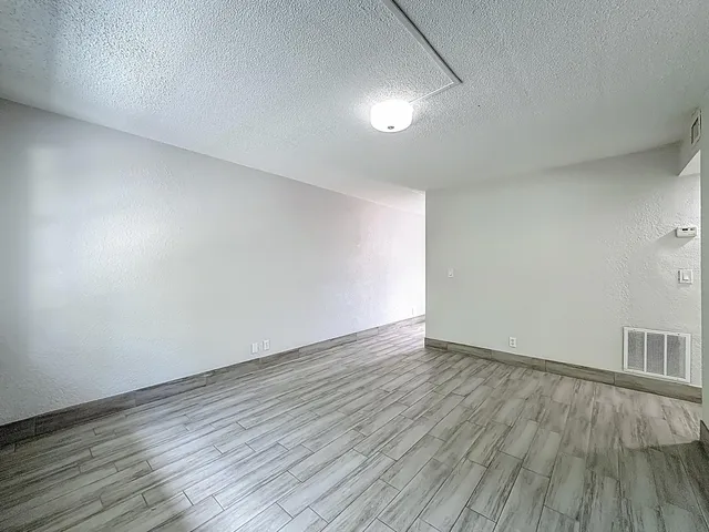 a view of an empty room and wooden floor