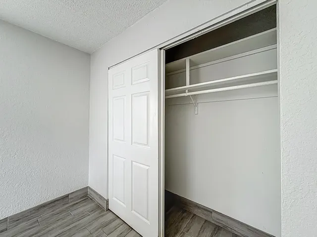 a view of closet area with wooden floor