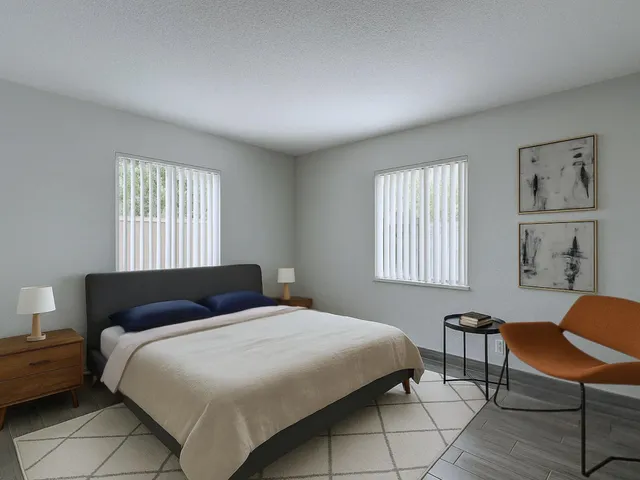 a bedroom with a bed chair and window