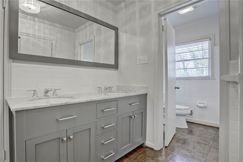 1195 Mt Paran Road Northwest Atlanta, GA 30327 - Photo 12 of 24 a bathroom with a granite countertop sink and a toilet