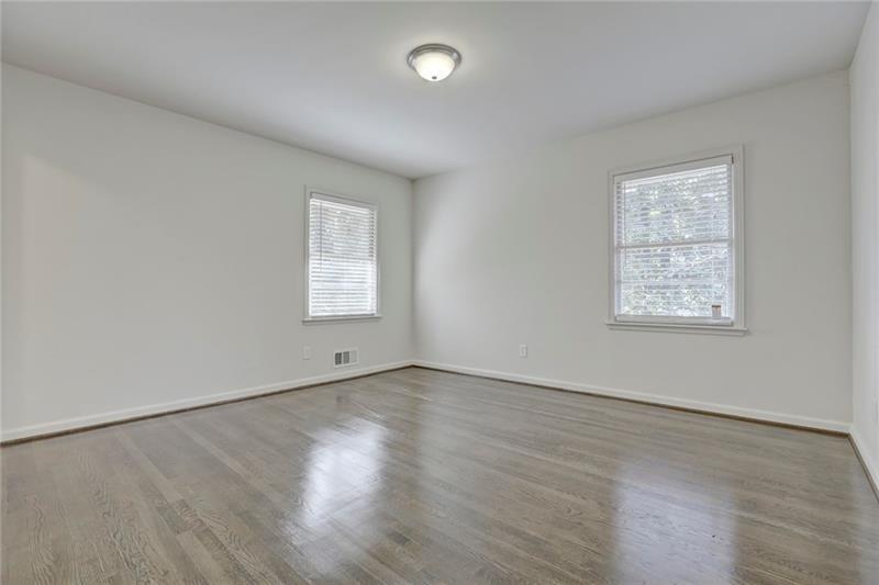 1195 Mt Paran Road Northwest Atlanta, GA 30327 - Photo 13 of 24 an empty room with wooden floor and windows