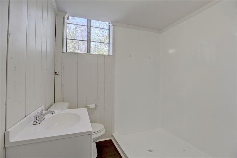 1195 Mt Paran Road Northwest Atlanta, GA 30327 - Photo 16 of 24 a bathroom with a sink a toilet and a mirror