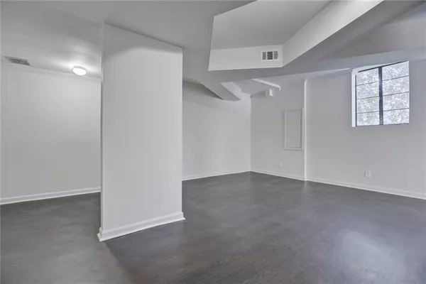 an empty room with windows and closet