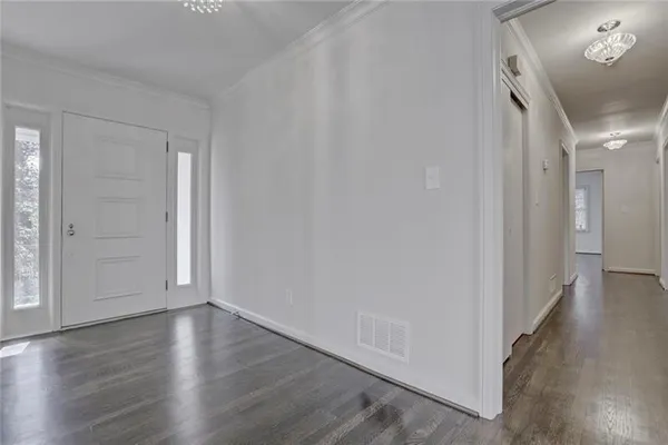 a view of a hallway with wooden floor