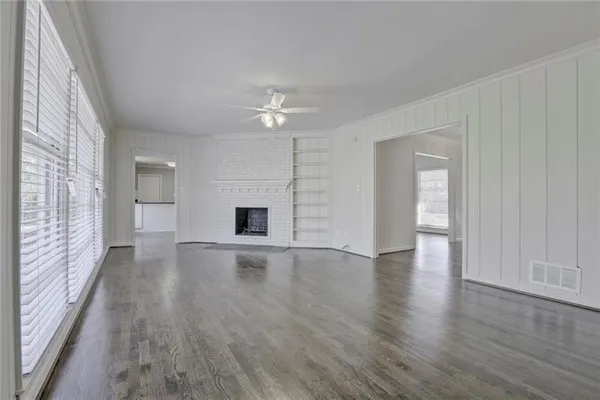 wooden floor in an empty room with a window