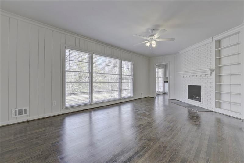 1195 Mt Paran Road Northwest Atlanta, GA 30327 - Photo 5 of 24 wooden floor in an empty room with a fireplace