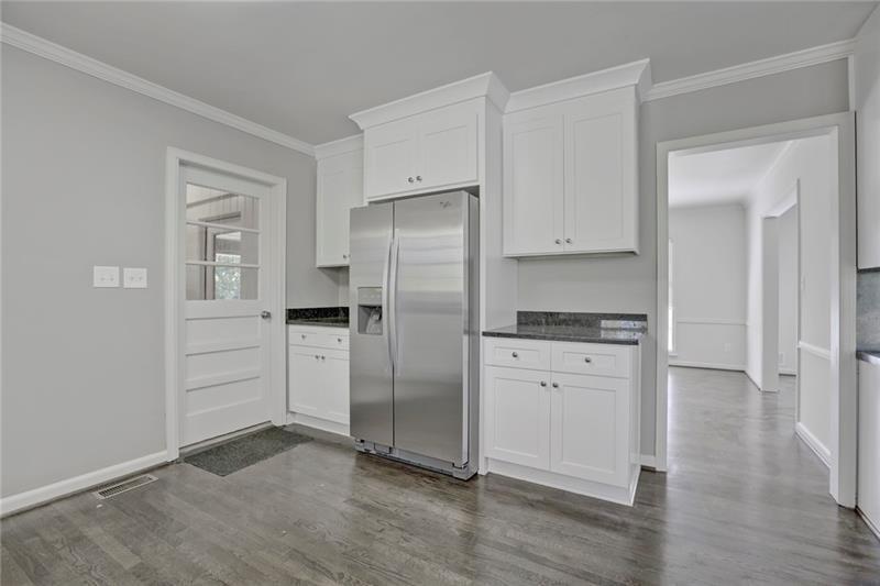 1195 Mt Paran Road Northwest Atlanta, GA 30327 - Photo 9 of 24 a kitchen with white cabinets and refrigerator