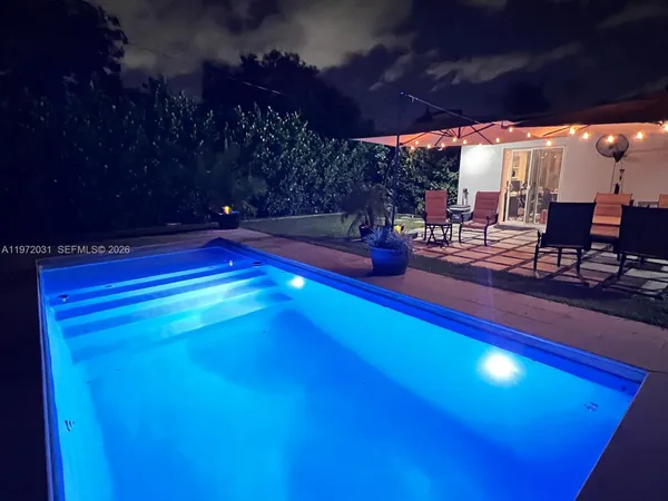 a view of swimming pool with outdoor seating