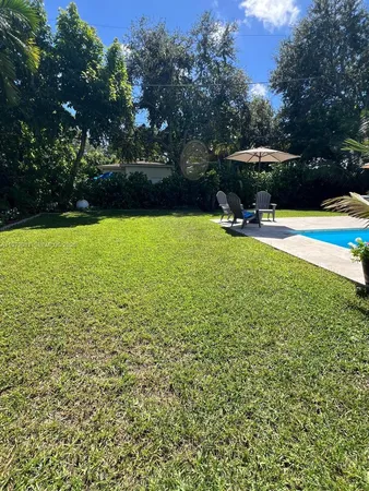 a view of a swimming pool and lounge chairs