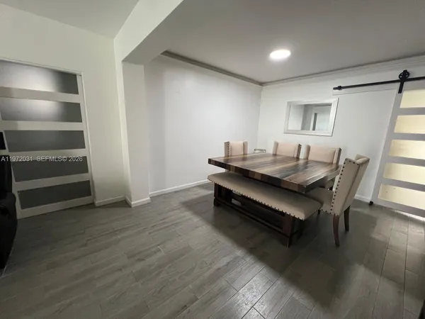 a dining room with furniture and wooden floor