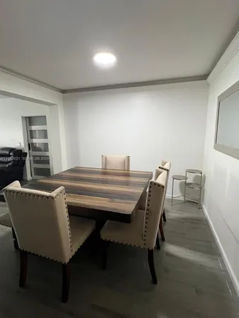 a living room with chairs and a table