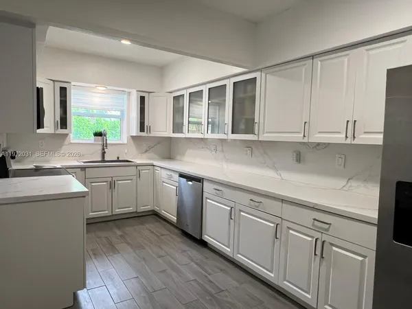 a kitchen with sink cabinets and window