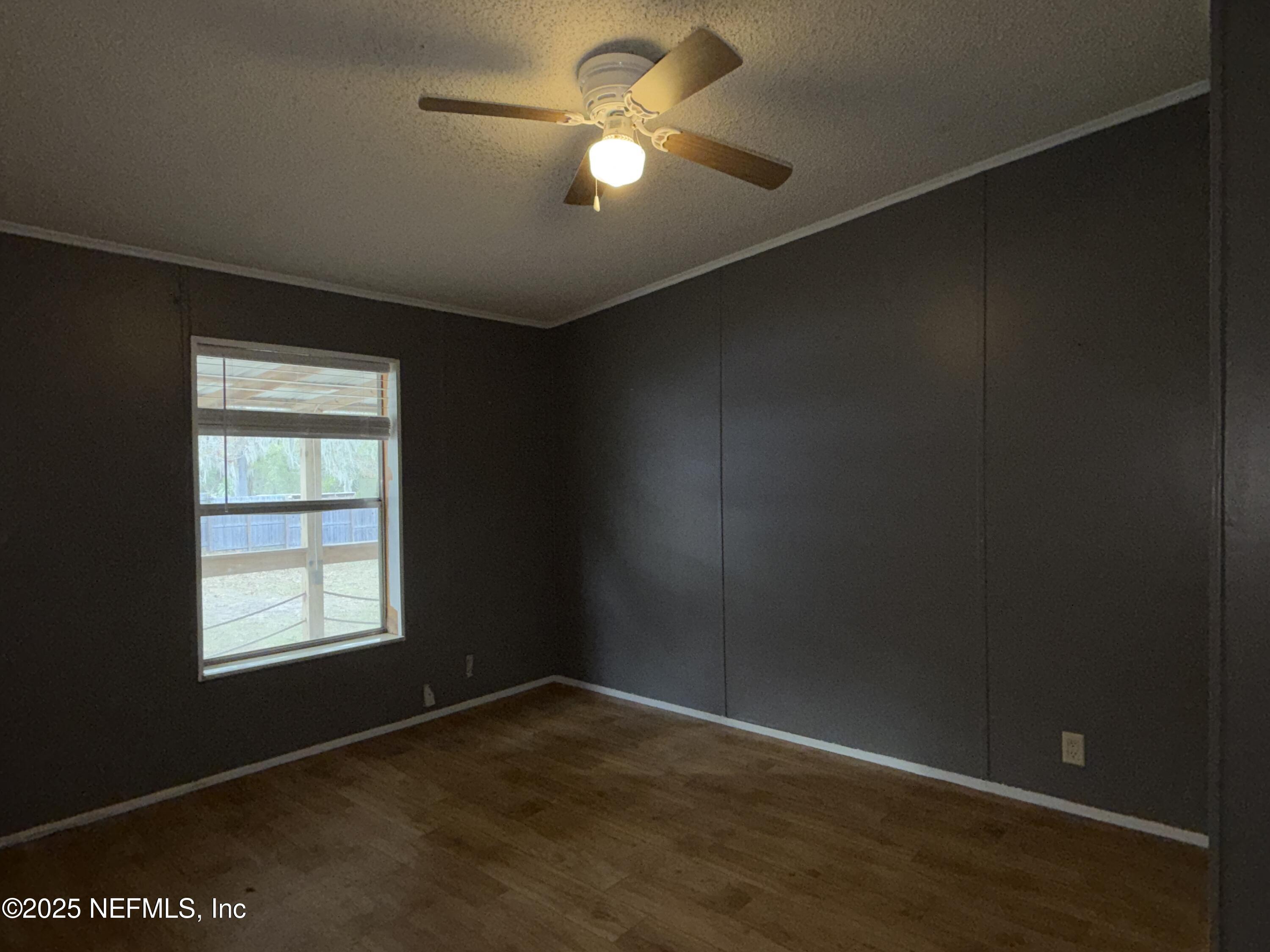 323 Incline Road Satsuma, FL 32189 - Photo 7 of 12 an empty room with a window and a ceiling fan
