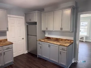 a kitchen with stainless steel appliances granite countertop a stove a refrigerator and a cabinets