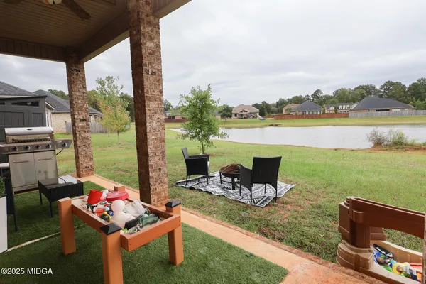 a view of a lake with couches and city view