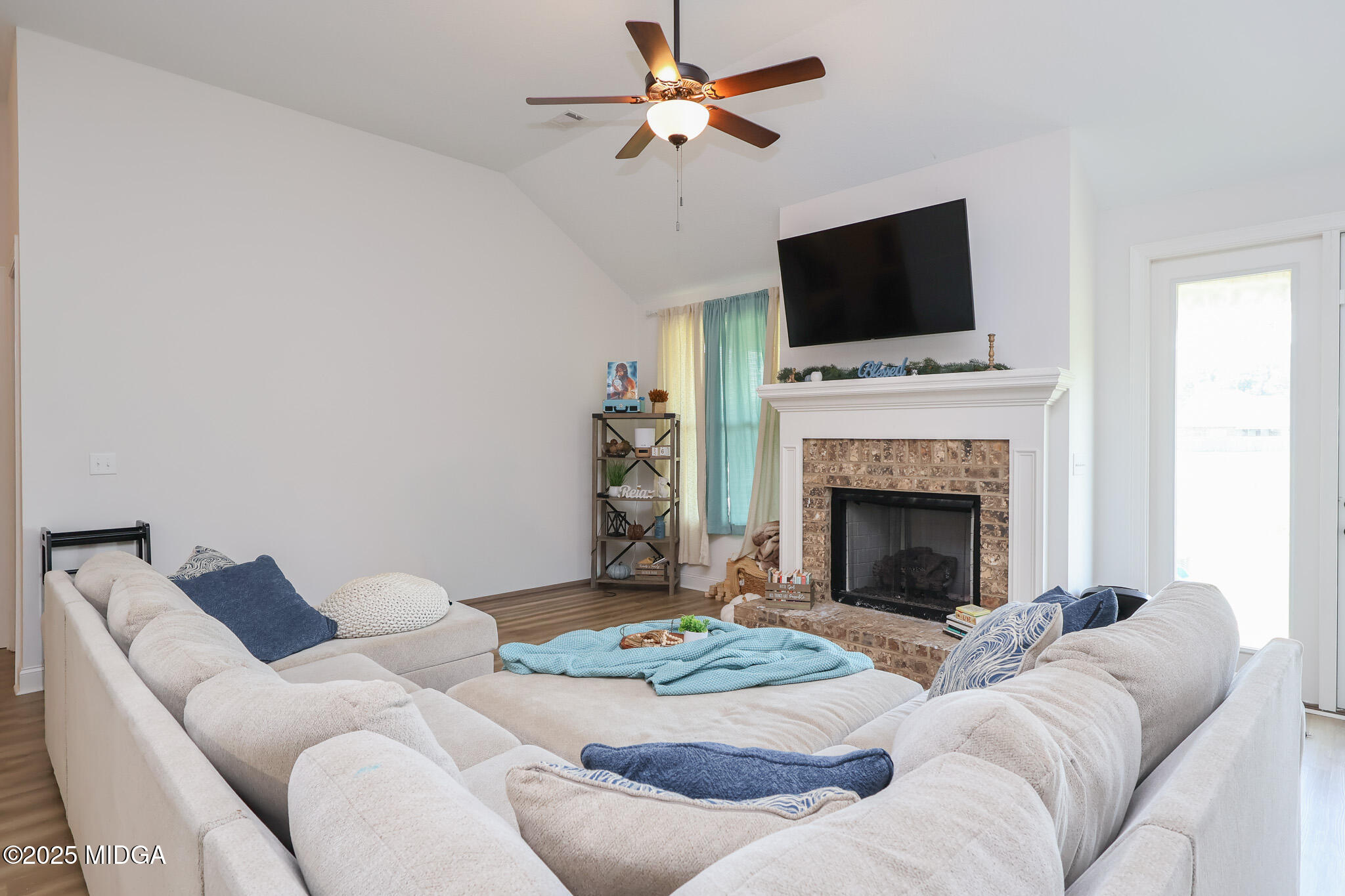 110 Gwendolyn Avenue Perry, GA 31069 - Photo 4 of 23 a living room with furniture a flat screen tv and a fireplace
