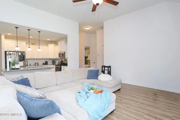 a living room with kitchen island furniture and a chandelier