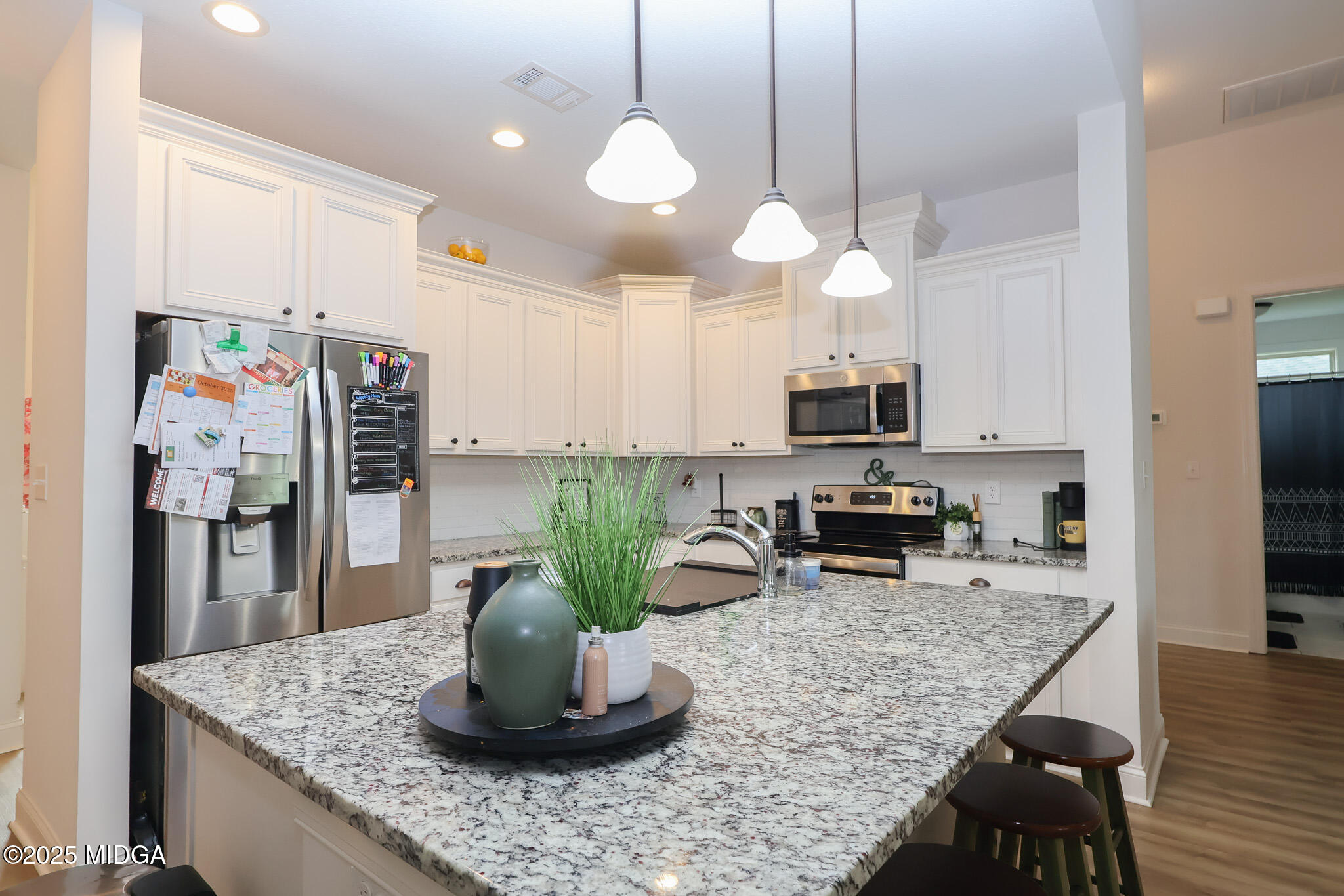 110 Gwendolyn Avenue Perry, GA 31069 - Photo 9 of 23 a kitchen with stainless steel appliances granite countertop a sink a stove and a wooden floors