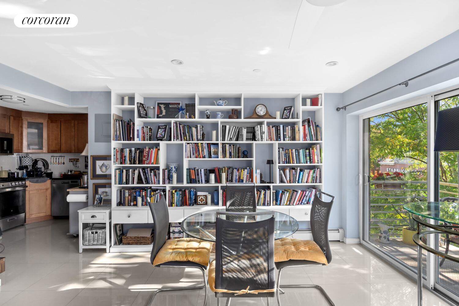 145 Kenilworth Place, Unit 3A Brooklyn, NY 11210 - Photo 3 of 10 a view of a workspace with furniture and a bookshelf