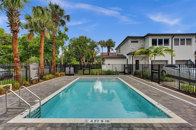 a view of house with swimming pool outdoor seating