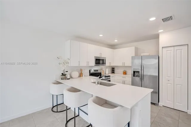 a kitchen with stainless steel appliances a refrigerator and a stove