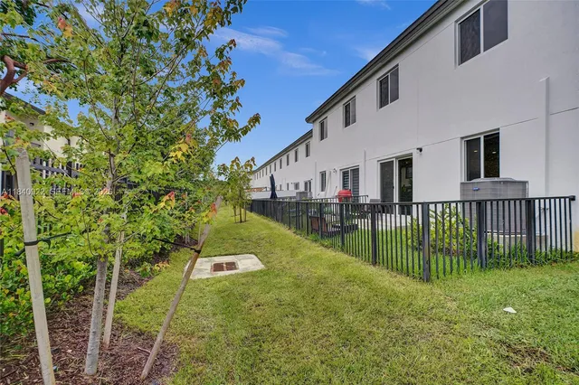 a view of a house with a yard and plants