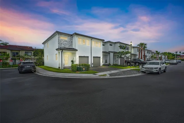 a front view of a house with a garden and parking space