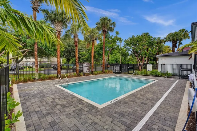 a view of a house with pool and a yard