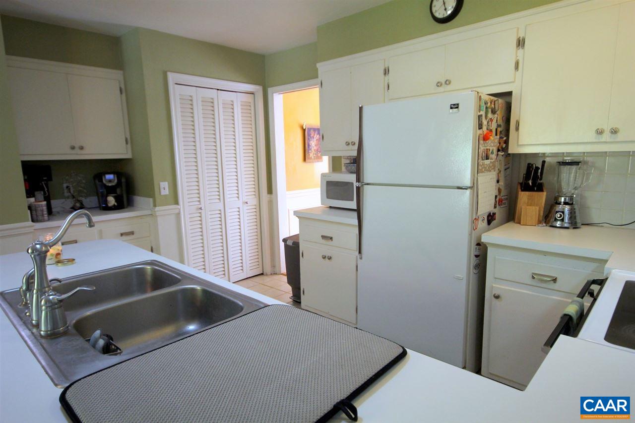 88 Good Hope Church Road Aroda, VA 22709 - Photo 7 of 30 a kitchen with a refrigerator sink and white cabinets