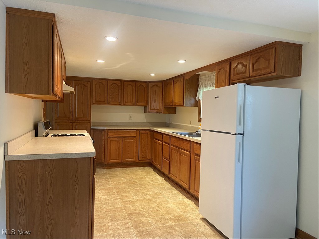 14092 Hatfield Road Rittman, OH 44270 - Photo 11 of 38 Kitchen featuring fridge, ventilation hood, stove, recessed lighting, and brown cabinets