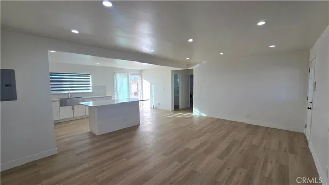 a kitchen with white cabinets and appliances