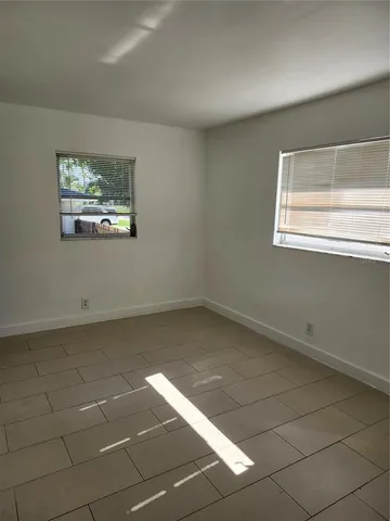 a view of a room with a window and a projector screen