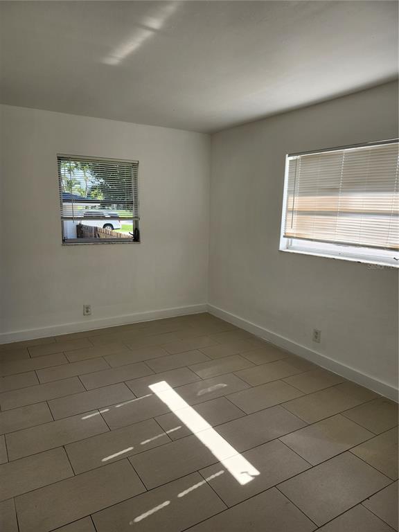 2921 Vasco Street, Unit B Punta Gorda, FL 33950 - Photo 7 of 10 a view of a room with a window and a projector screen