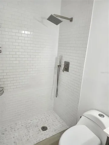 a bathroom with a toilet and shower