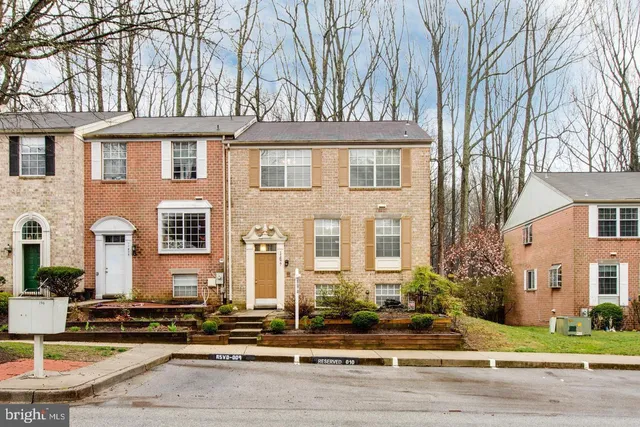 front view of a brick house with a yard