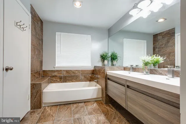 a spacious bathroom with a bathtub and a sink