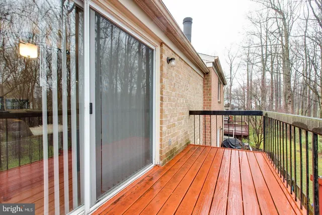 a view of backyard with a deck and wooden floor