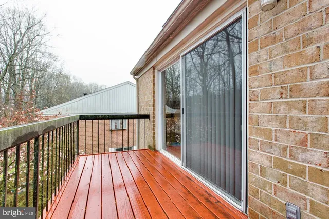 a view of balcony with wooden floor and fence