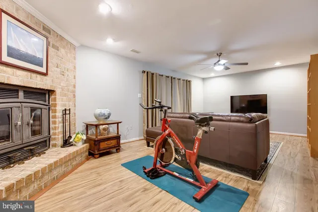 a view of a livingroom with workspace and a fireplace