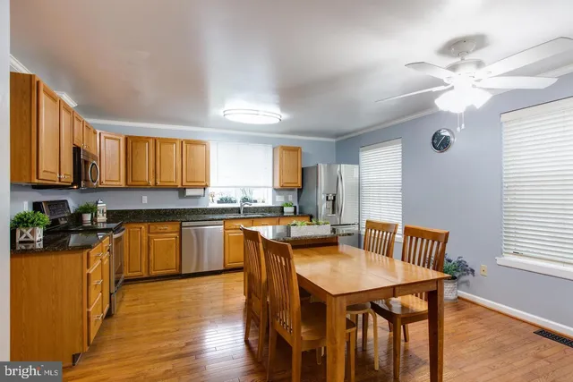 a kitchen with a table chairs stove and cabinets