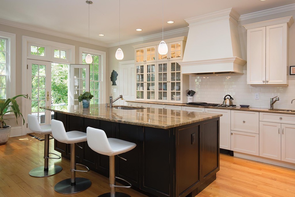 14 Milton Road Brookline, MA 02445 - Photo 6 of 10 a kitchen with granite countertop sink stove and white cabinets with wooden floor