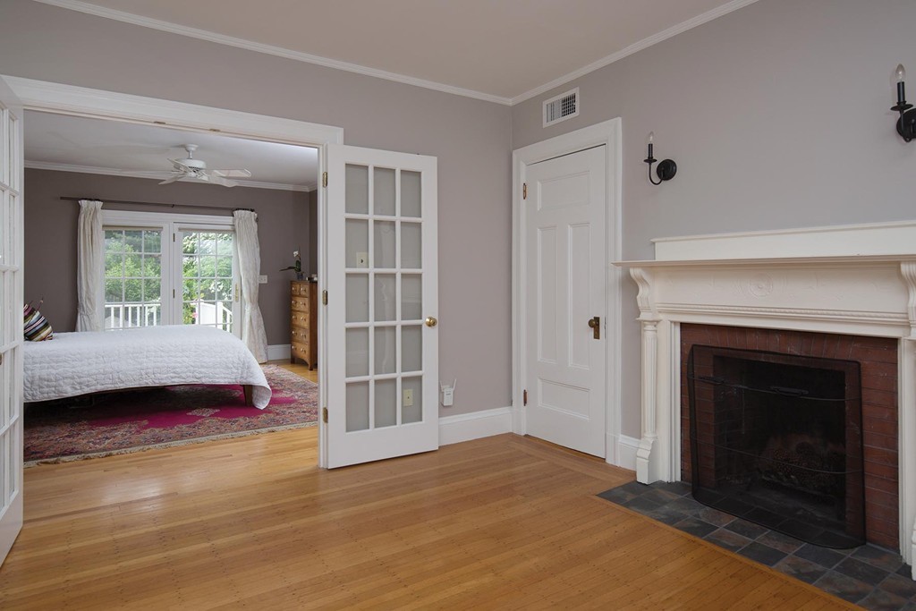 14 Milton Road Brookline, MA 02445 - Photo 7 of 10 a bedroom with a bed and a fireplace