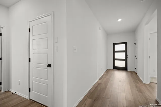 an empty room with wooden floor and closet