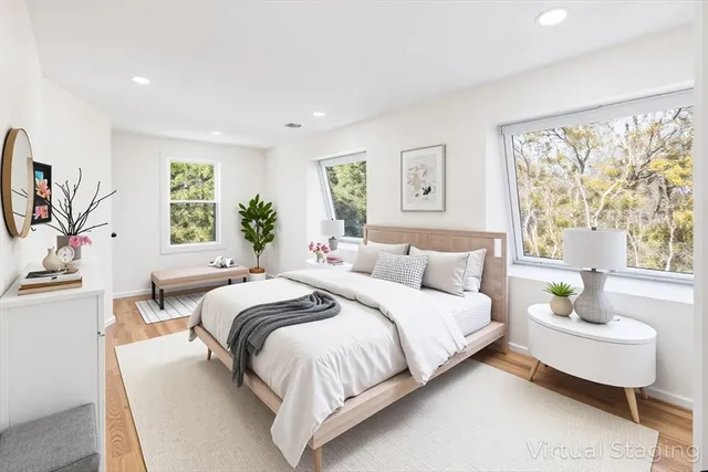 a bedroom with a bed couch and window