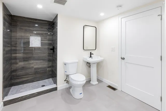 a bathroom with a toilet and a shower