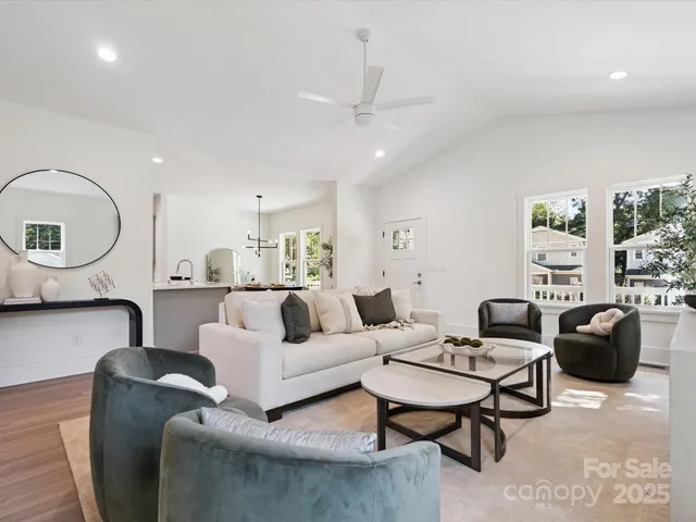 a living room with furniture a rug and a chandelier