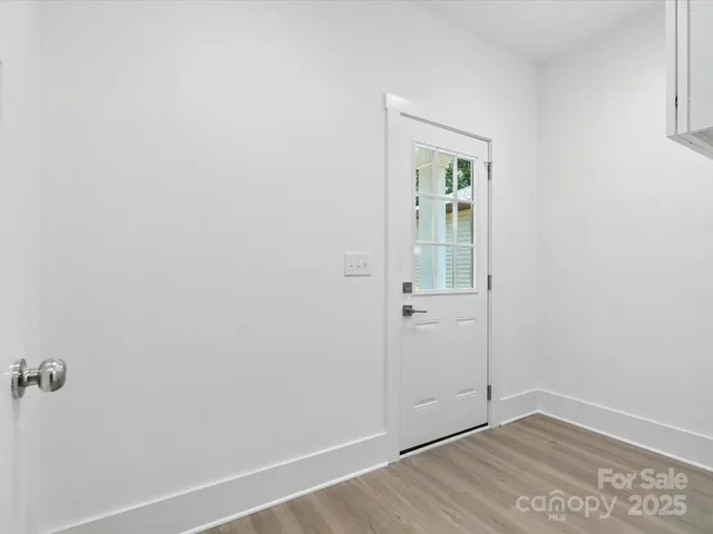 an empty room with wooden floor and closet